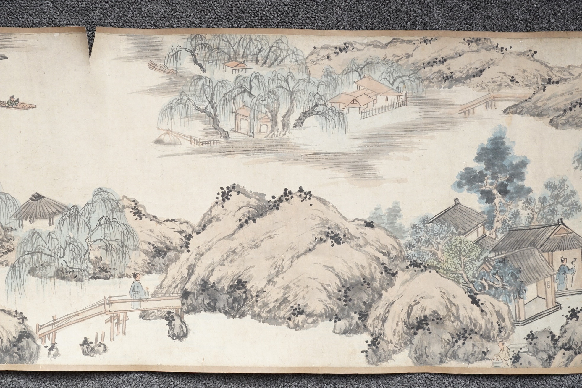 Chinese School , (Qing dynasty), Figures in a mountainous river landscape, Ink and colour on paper handscroll, 268.5cm x 29cm excluding borders